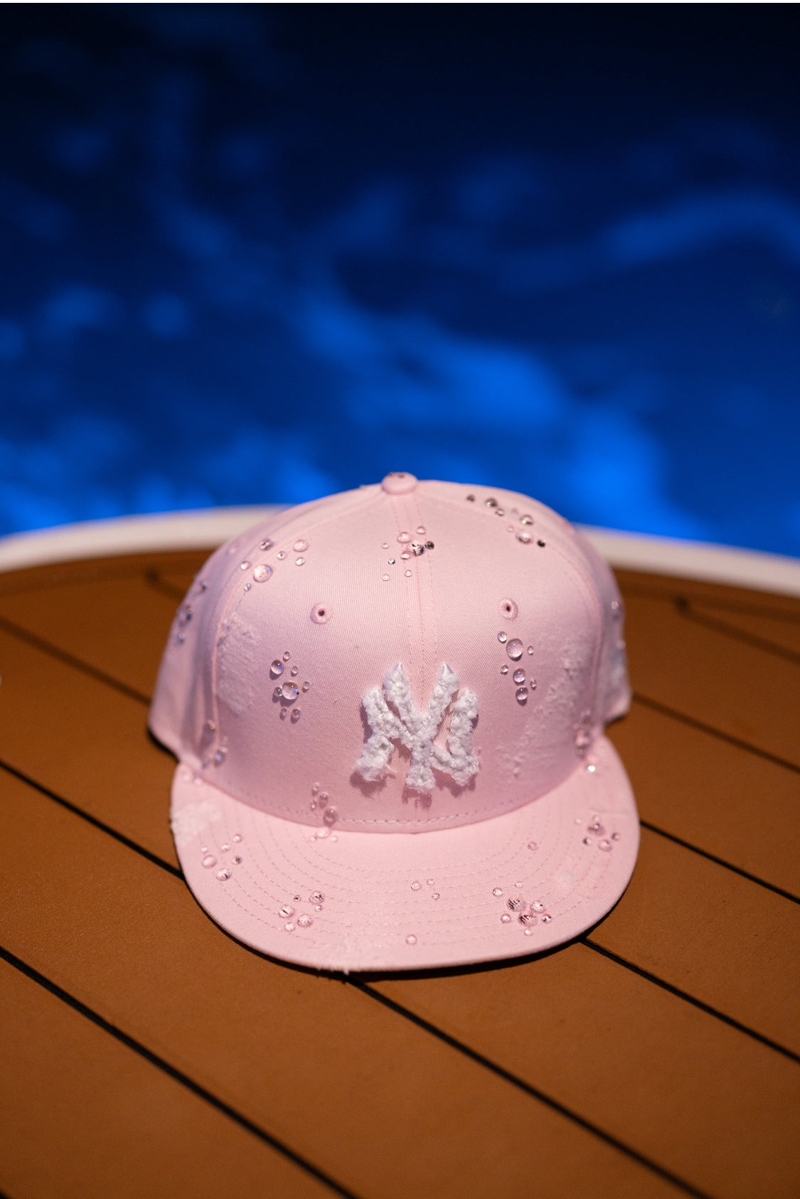 Pink NY Yankees New Era cap with a water droplet design