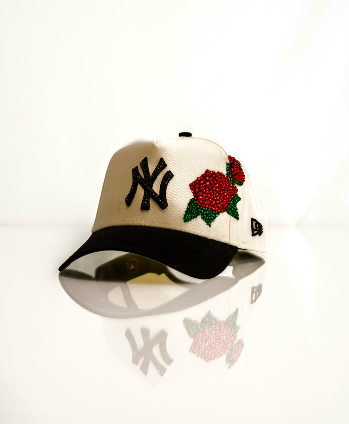 White and black NY cap with rhinestone rose design